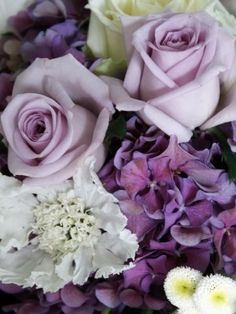 Purple Tiger Pride - a mix of purple and white flowers wrapped in purple and white themed tissue paper